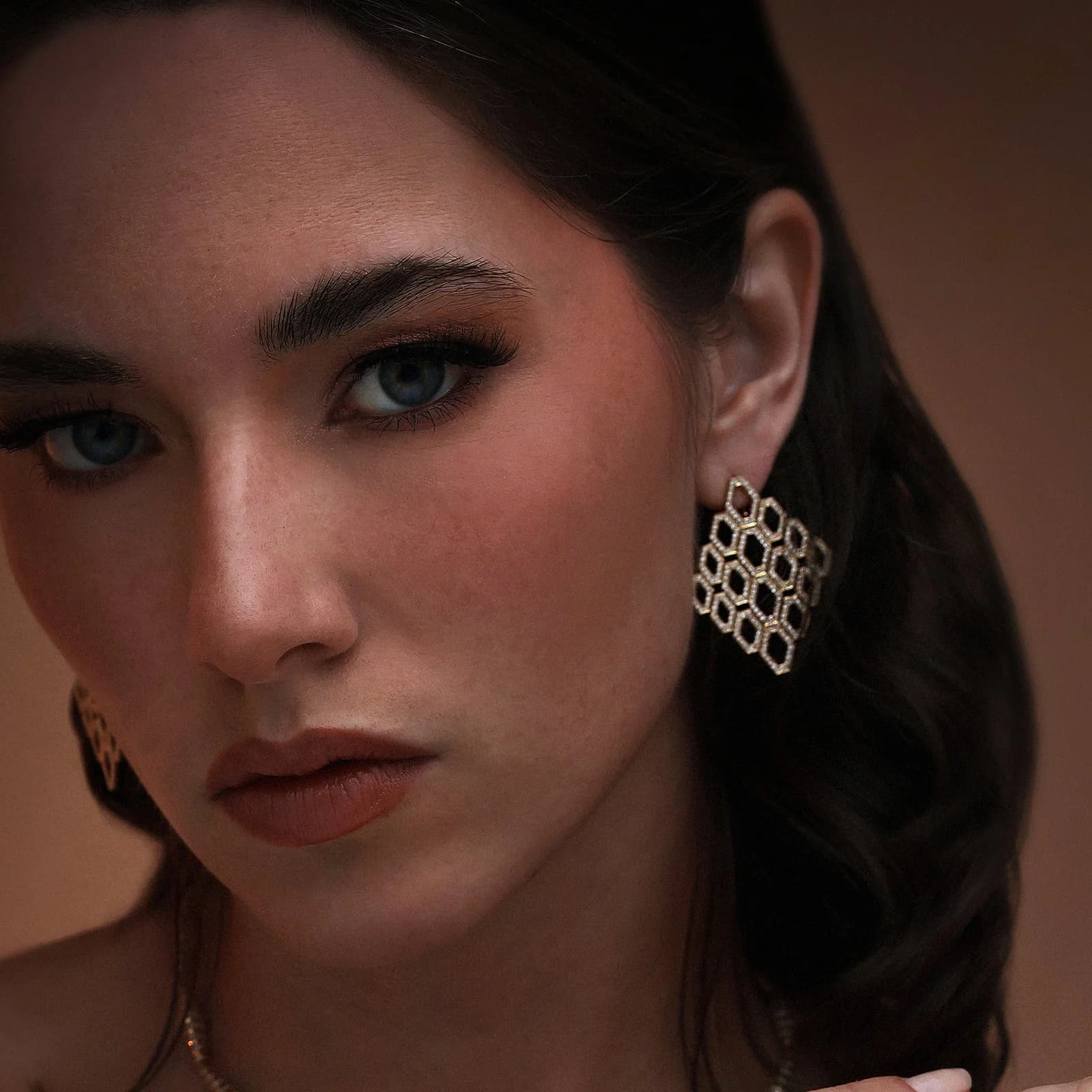 Dina J campaign portrait highlighting sculptural jewelry