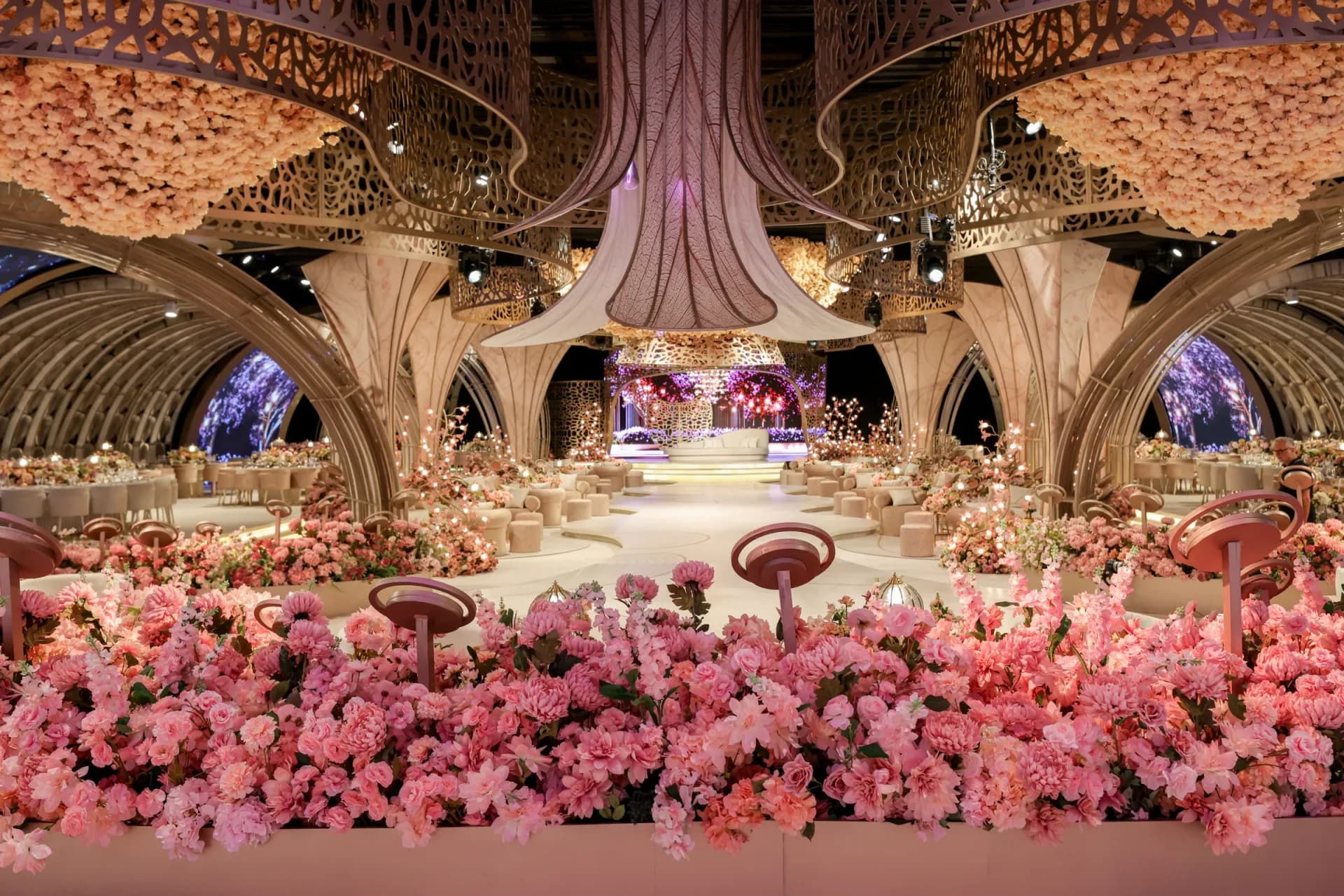 Etoile Signature reception with floral arrangements and sculptural arches