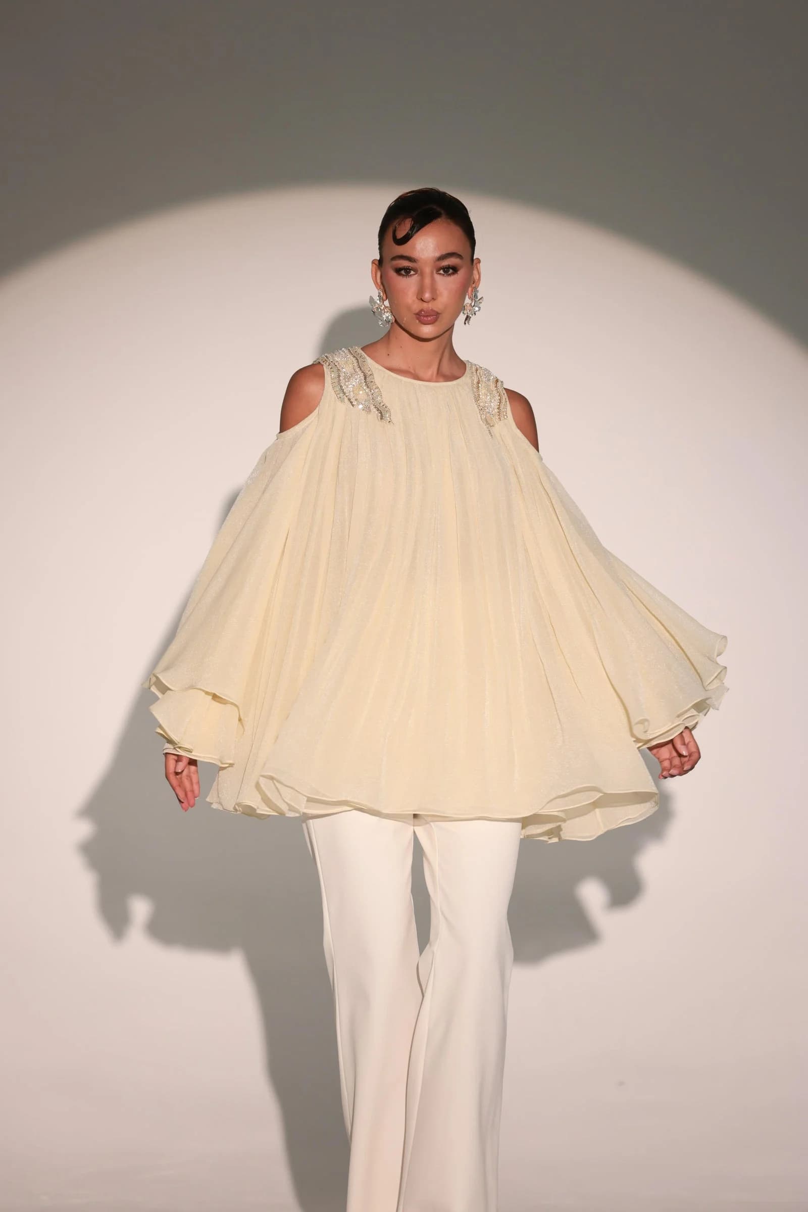 Li Luce campaign model in a sculptural ivory outfit