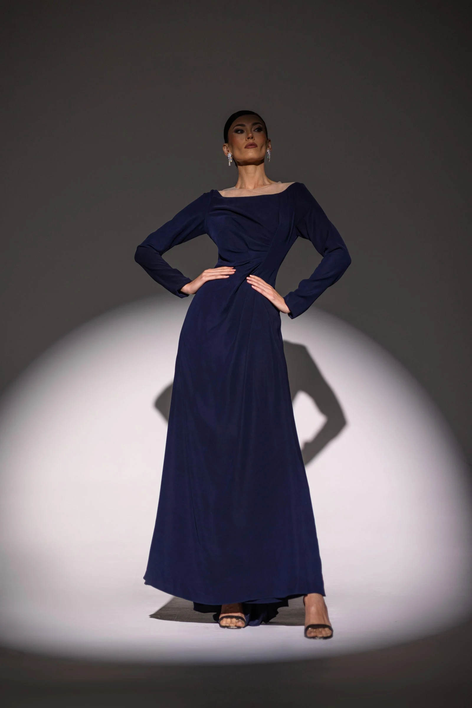 Li Luce campaign model wearing a flowing navy dress