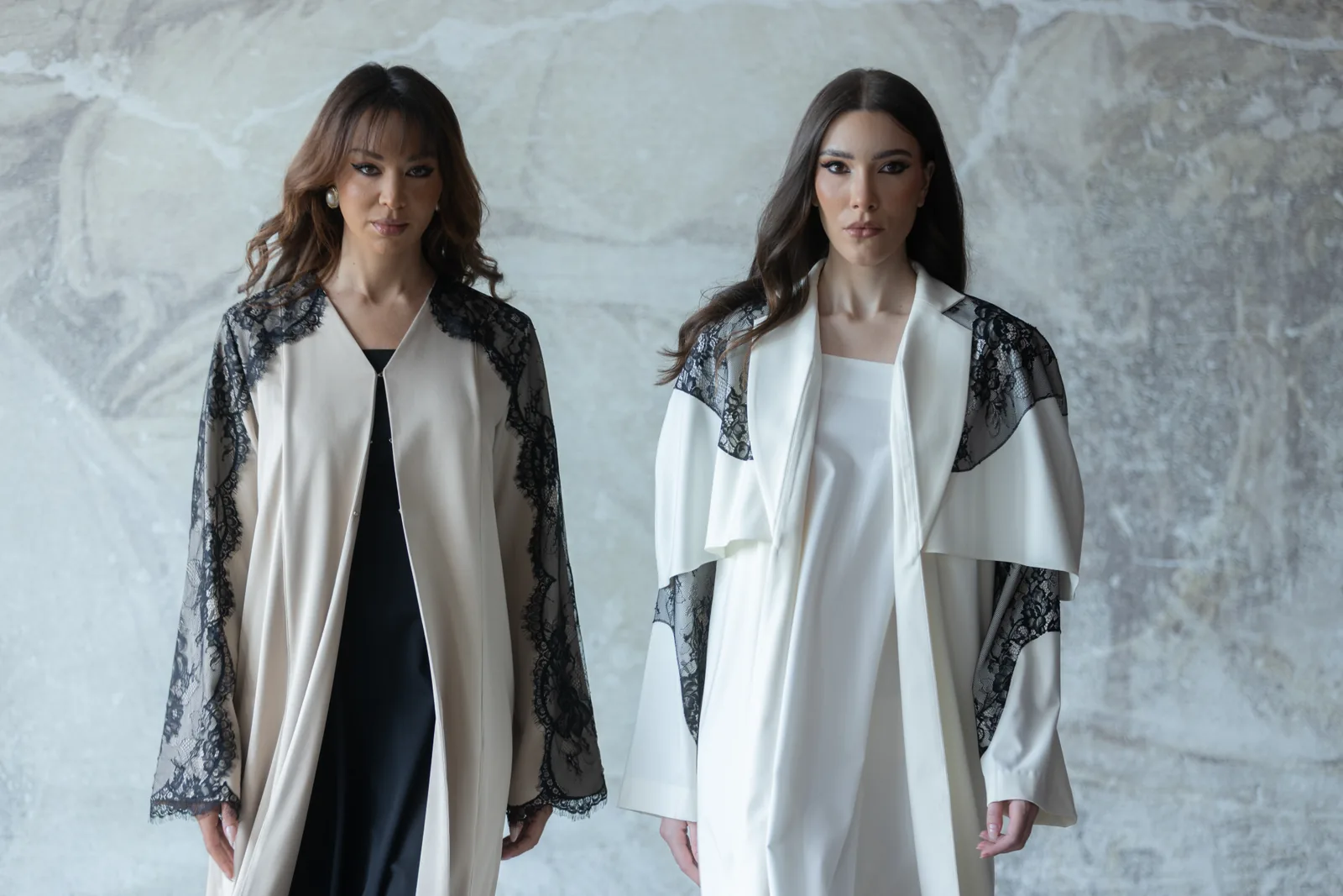 Two Pearelle campaign models wearing ivory garments with black lace details