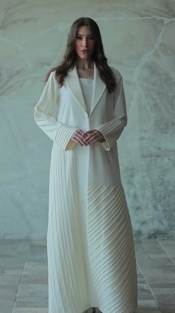 Pearelle editorial: a model in a long ivory coat