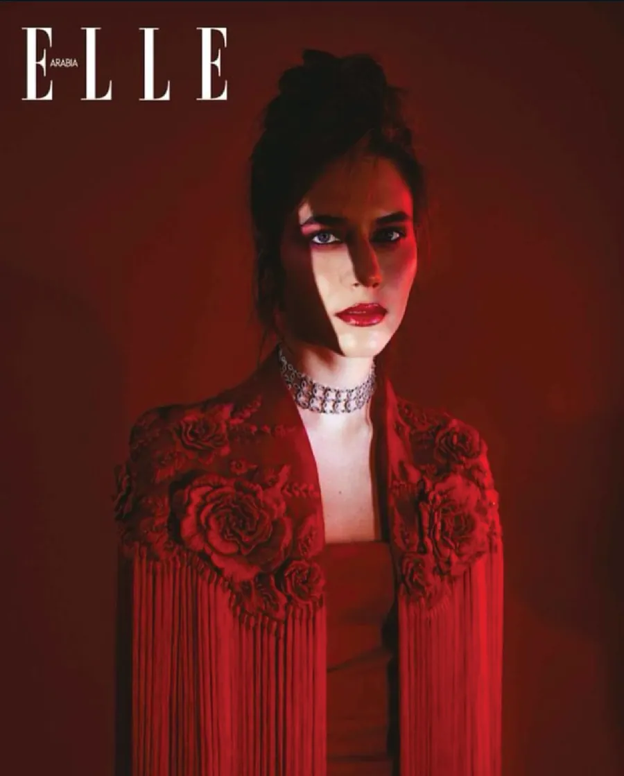 ELLE Arabia cover with a model in a red embroidered fringed cape