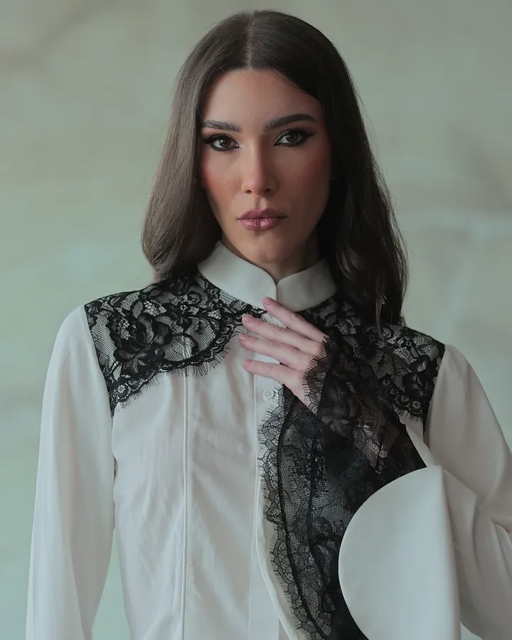 Pearelle portrait in a white shirt with black lace