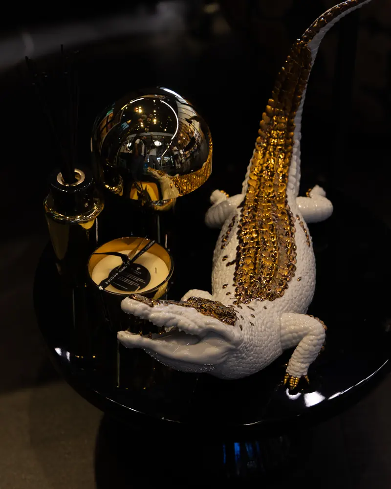 Cities store: a white and gold crocodile sculpture