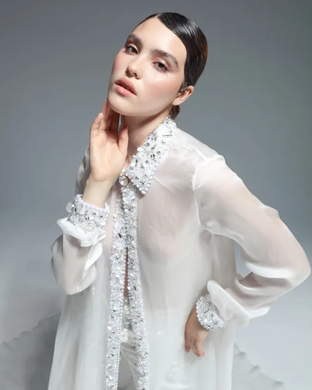 Studio portrait of a model in an Elio Abou Fayssal embellished organza shirt