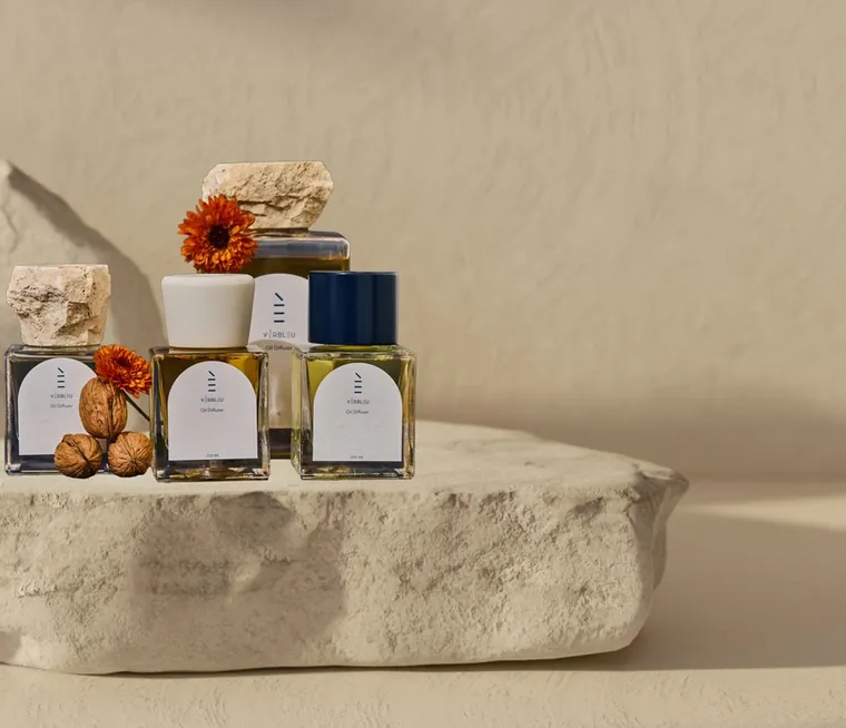 Verbleu diffusers arranged on a stone plinth