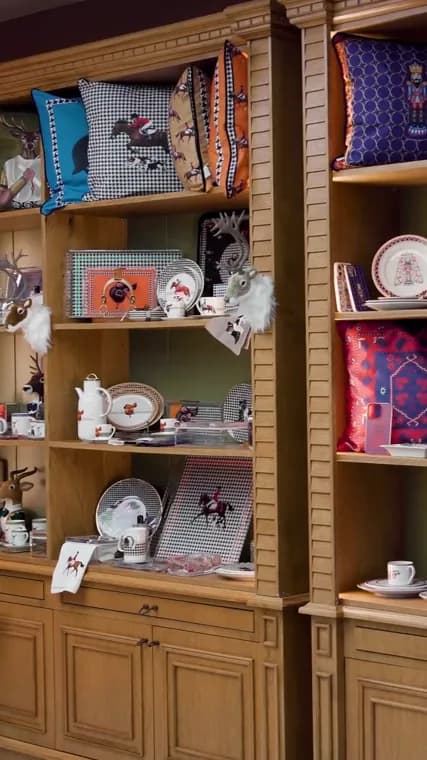 Vitelli showroom shelves with equestrian cushions, plates and trays