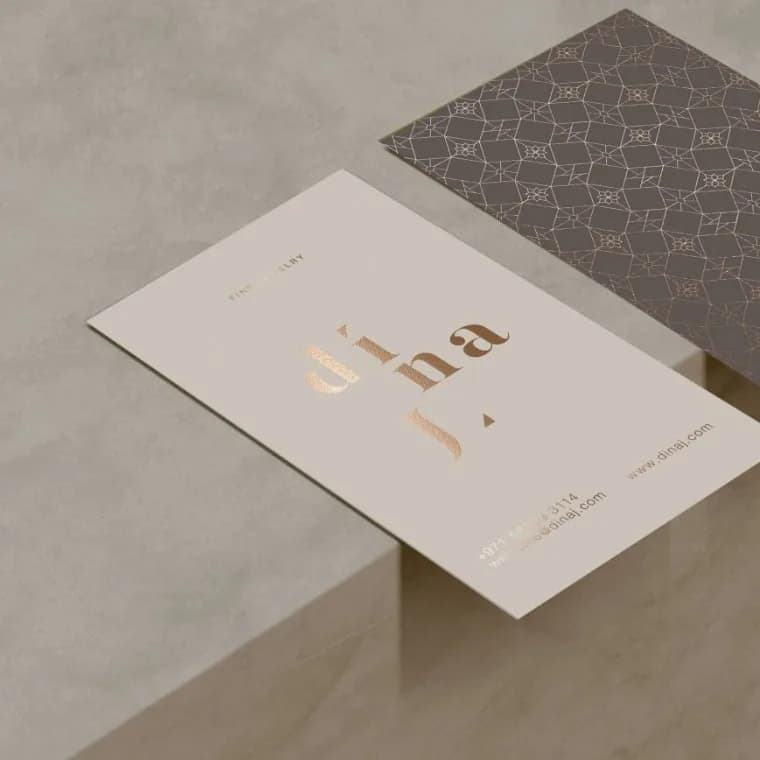 Dina J business cards in champagne foil with embossing