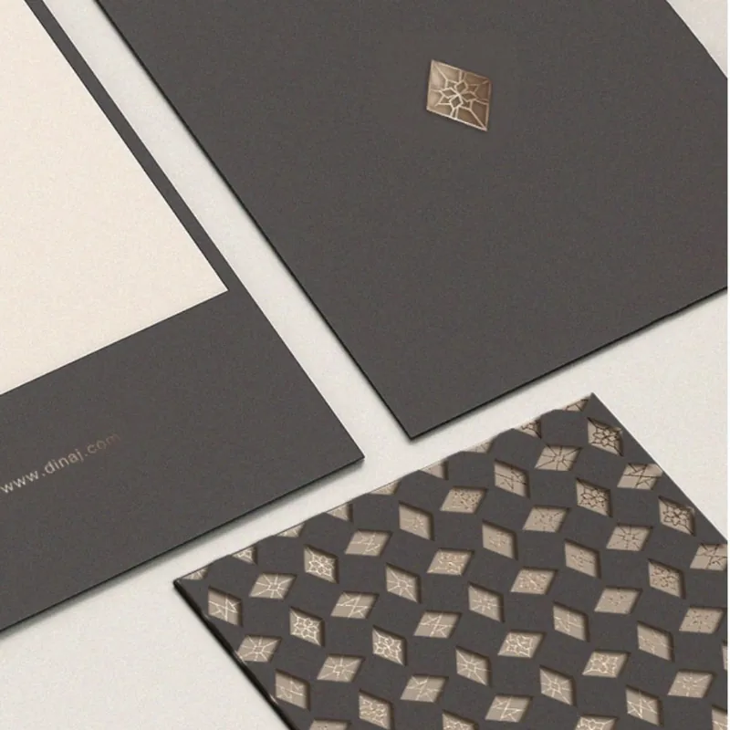 Dina J presentation folder with the foil emblem and the brand pattern